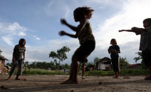 CCT program in Central Mindanao working well. The caption, Children covered by CCT program play outside their homes in the city of General Santos. 