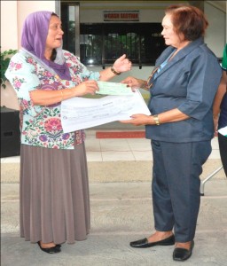 DSWD-12 Regional Director Bai Zorahayda T. Taha hands over a P1.6-M amount of check to Bagumbayan Mayor Bernardita R. Bito-onon for the construction of crisis center