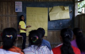 A volunteer working for CCT program teaches T'boli native women regarding basic education in Lake Sebu town in South Cotabato. 